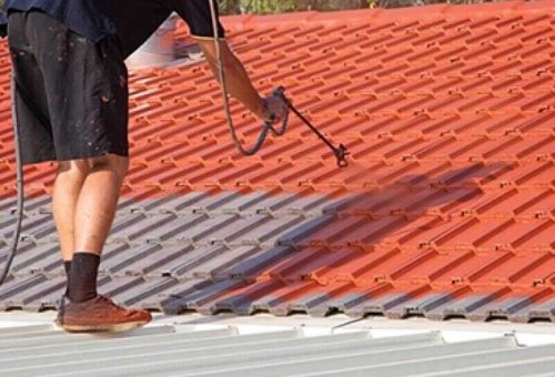 person-painting-a-roof-tile-with-an-airless-sprayer